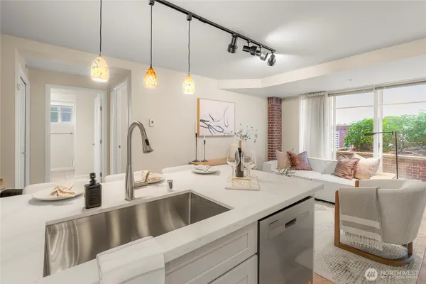 a view of a kitchen island a sink and living room view