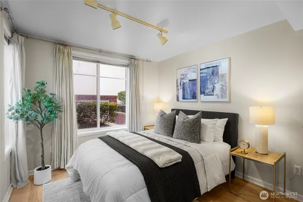 a bedroom with furniture and a large window
