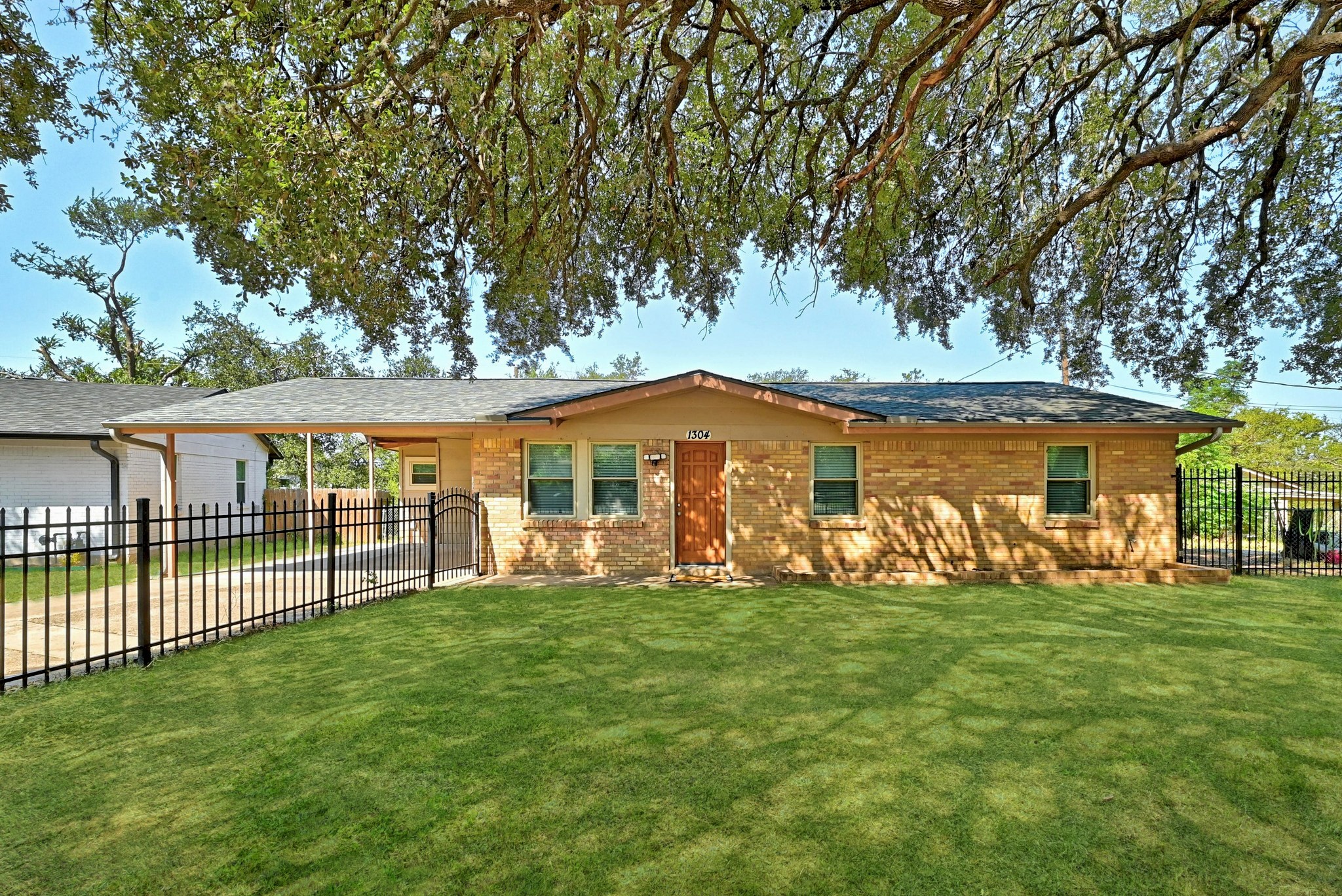 1304 Astor Place Austin, TX 78721 - Photo 1 of 1 Front yard virtually enhanced grass
