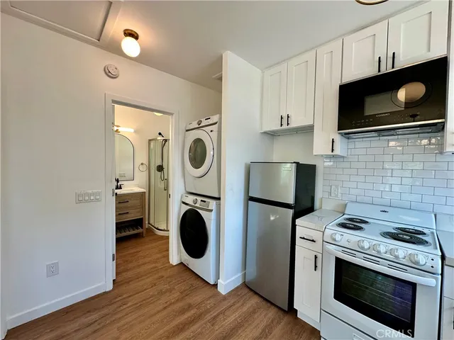 a kitchen with a stove top oven microwave and refrigerator