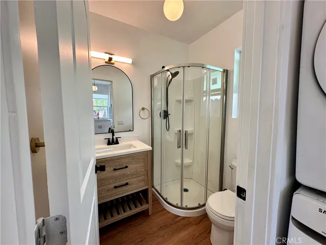 a bathroom with a double vanity sink toilet mirror and shower