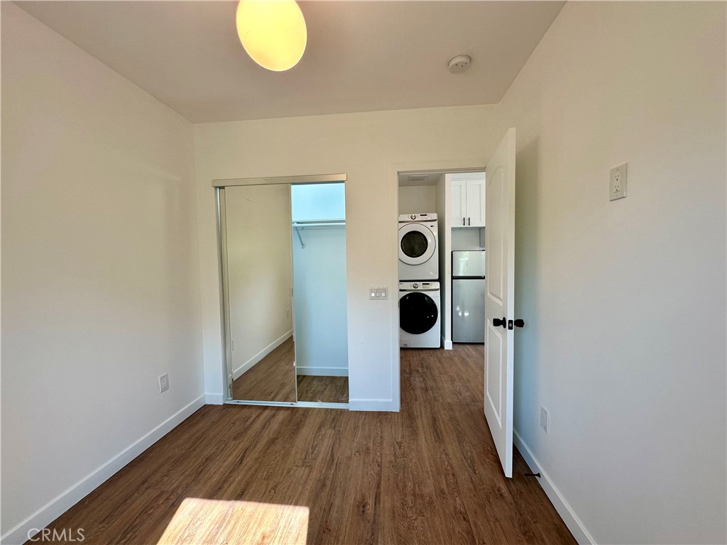227 East Main Street, Unit B San Gabriel, CA 91776 - Photo 7 of 7 an empty room with wooden floor and mirror