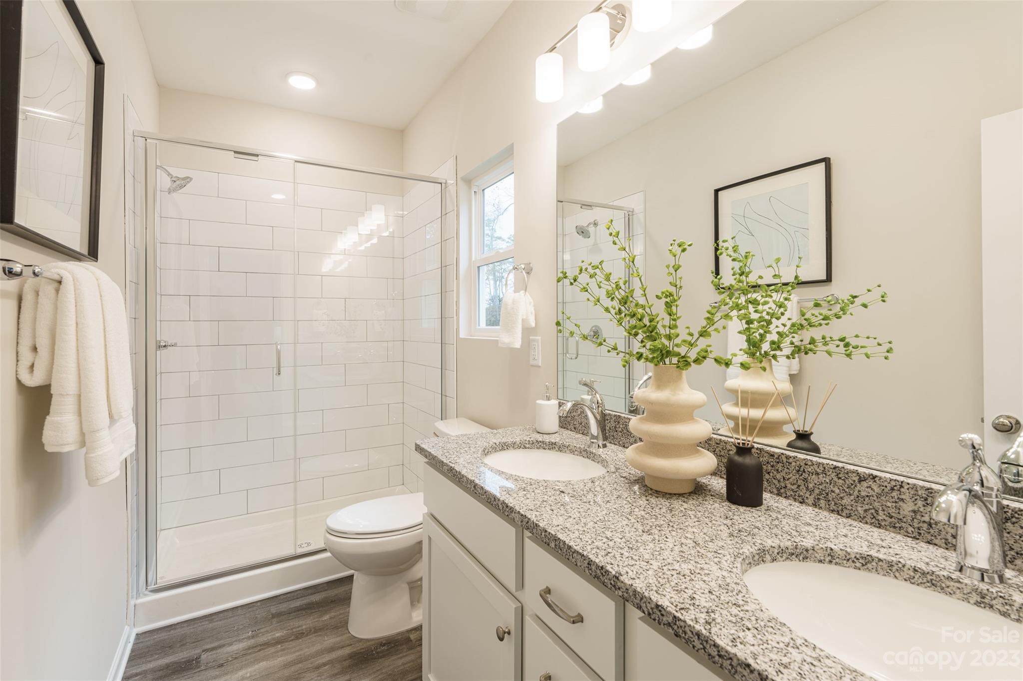 2113 Tom Sadler Road Charlotte, NC 28214 - Photo 17 of 31 a bathroom with a granite countertop sink a toilet and shower