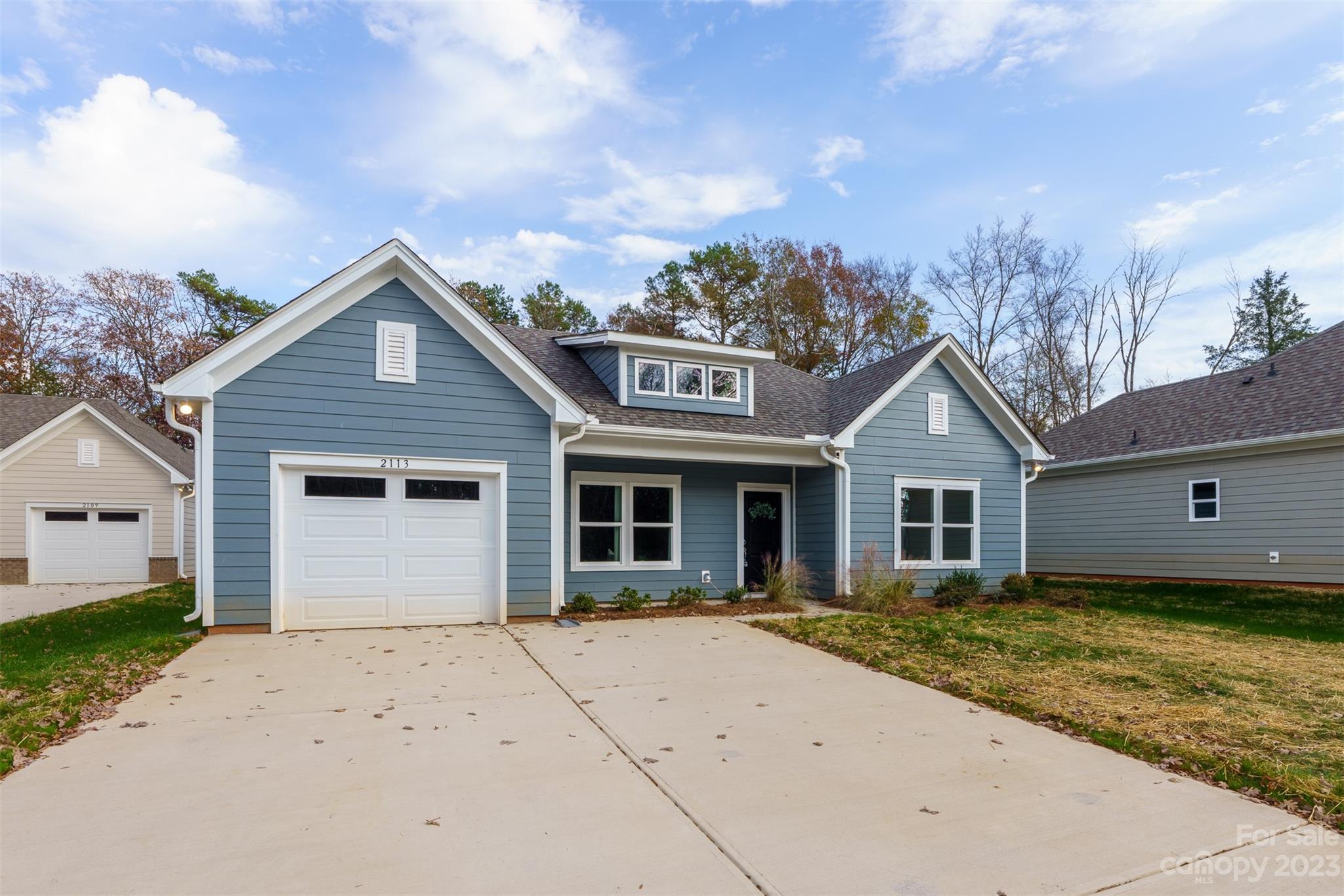 2113 Tom Sadler Road Charlotte, NC 28214 - Photo 2 of 31 a front view of a house with a yard and garage
