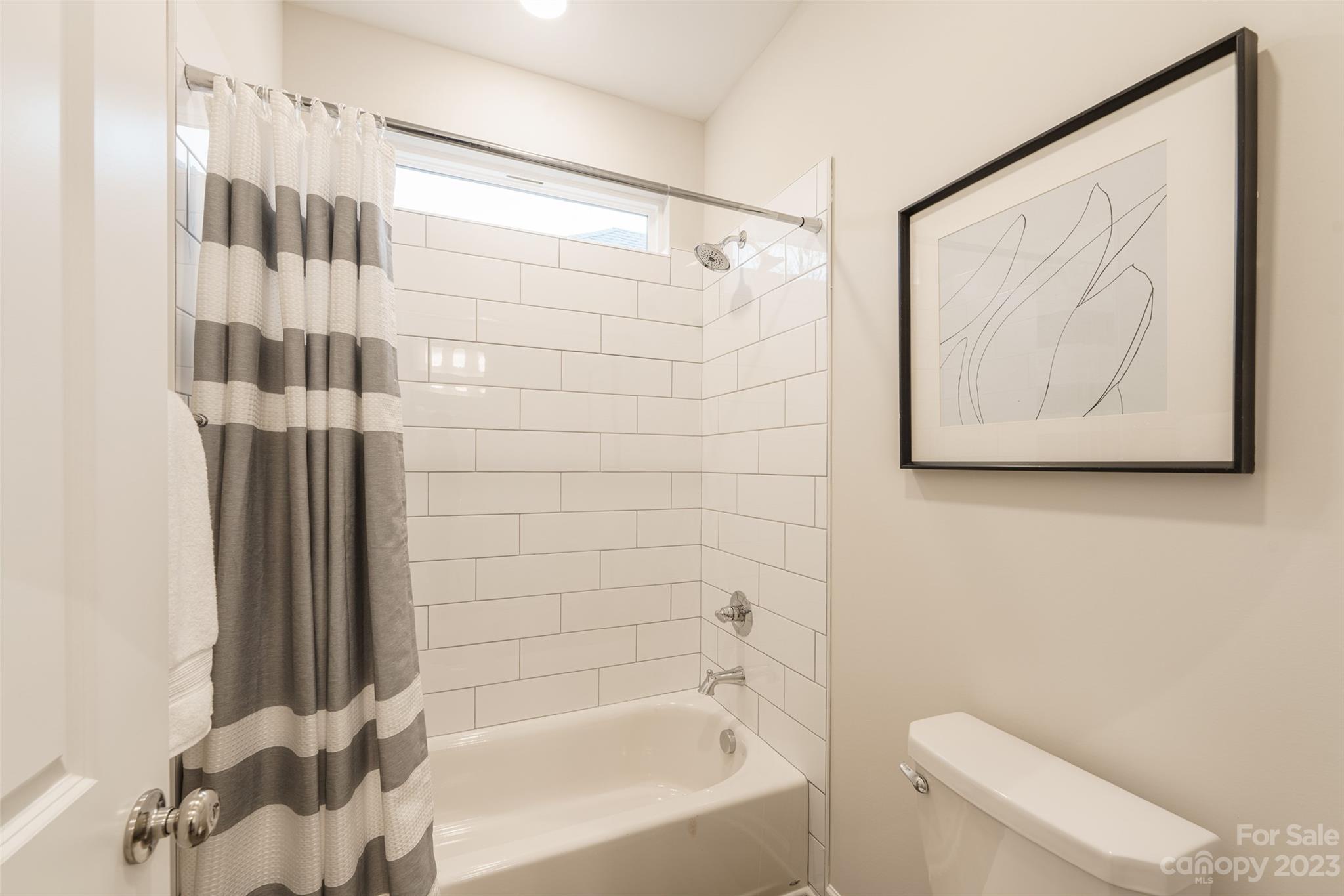 2113 Tom Sadler Road Charlotte, NC 28214 - Photo 23 of 31 a bathroom with a bathtub and shower