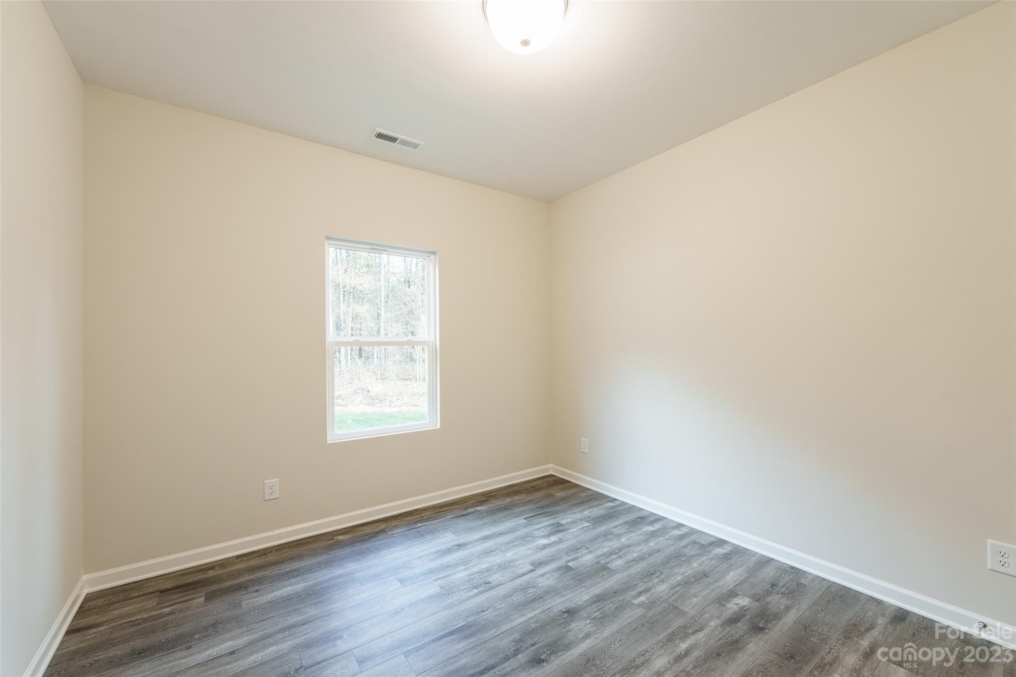 2113 Tom Sadler Road Charlotte, NC 28214 - Photo 24 of 31 an empty room with wooden floor and window