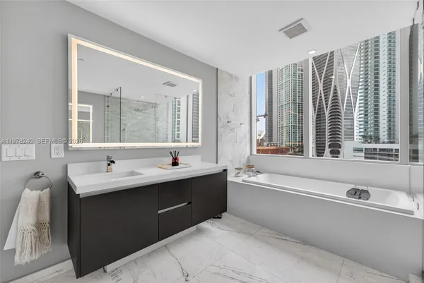 a bathroom with a double vanity sink and a bathtub