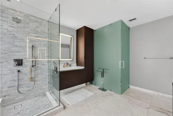 a bathroom with a shower and a sink