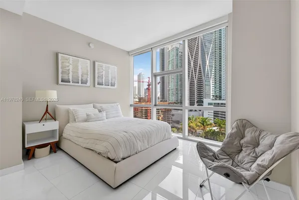 a bedroom with a bed and glass window