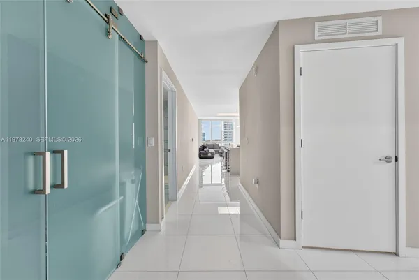 a view of a hallway with closet and a couch