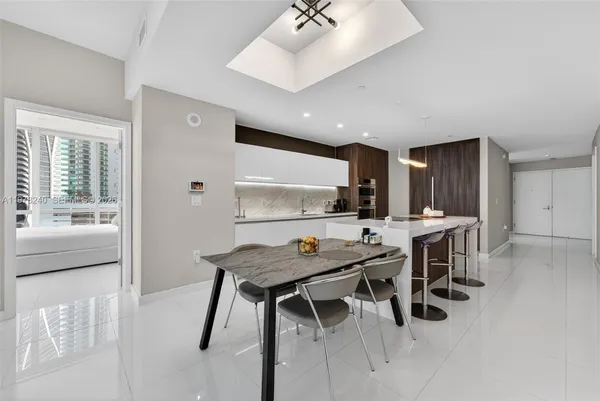 a kitchen with a table and chairs in it