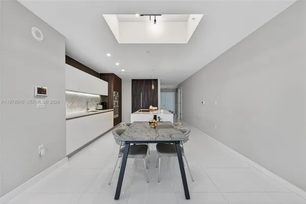 a kitchen with a table and chairs