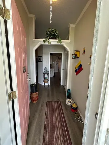 a view of a entryway of a house with wooden floor