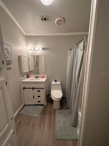 a bathroom with a sink a toilet and mirror