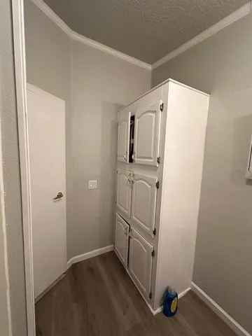 a view of storage and utility room with refrigerator