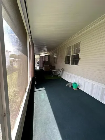a view of a balcony with wooden floor and stairs