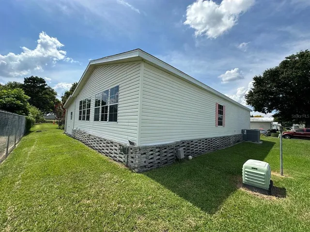 a backyard of a house with table and chairs