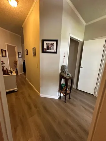 a view of a workspace with furniture and wooden floor