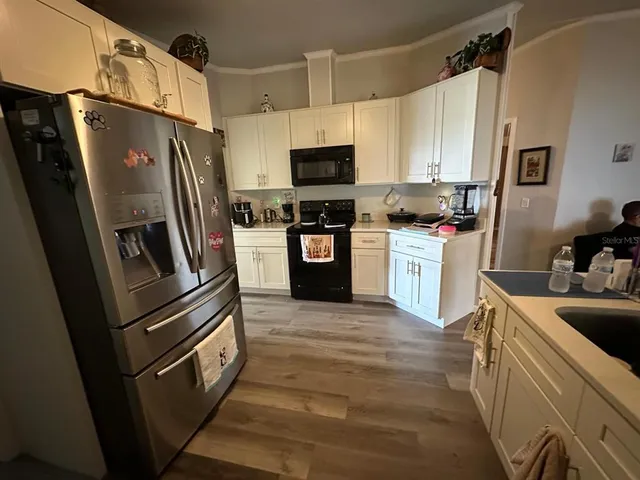 a kitchen with stainless steel appliances and refrigerator