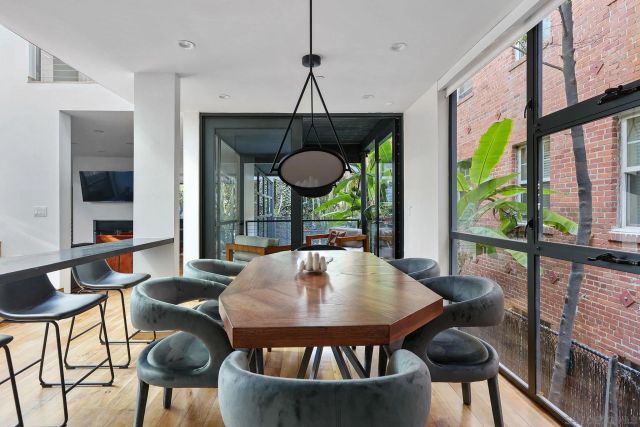 a dining room with furniture a window and a chandelier
