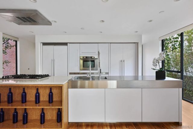 a kitchen with stainless steel appliances a stove a sink and a refrigerator