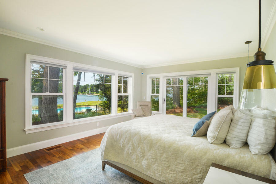 71 Sand Point Osterville, MA 02655 - Photo 27 of 45 a bed sitting in a bedroom next to a large window