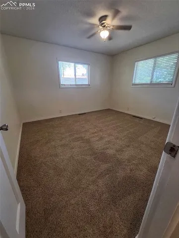a view of an empty room and a window