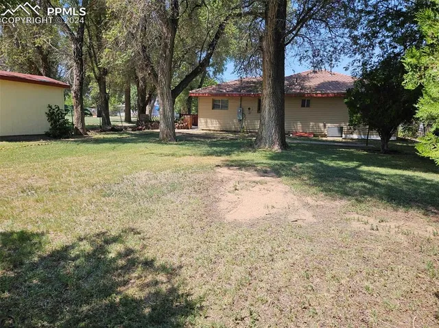 a backyard of a house with lots of green space