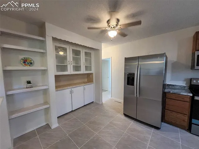 a kitchen with a refrigerator and cabinets