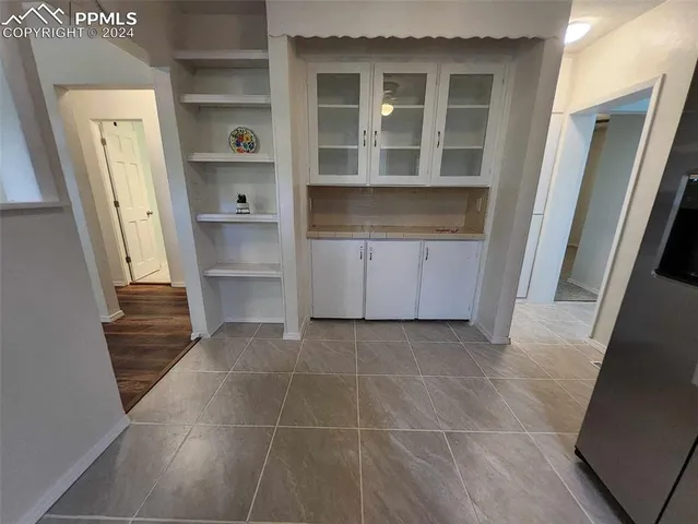 a room with washing machine and cabinets