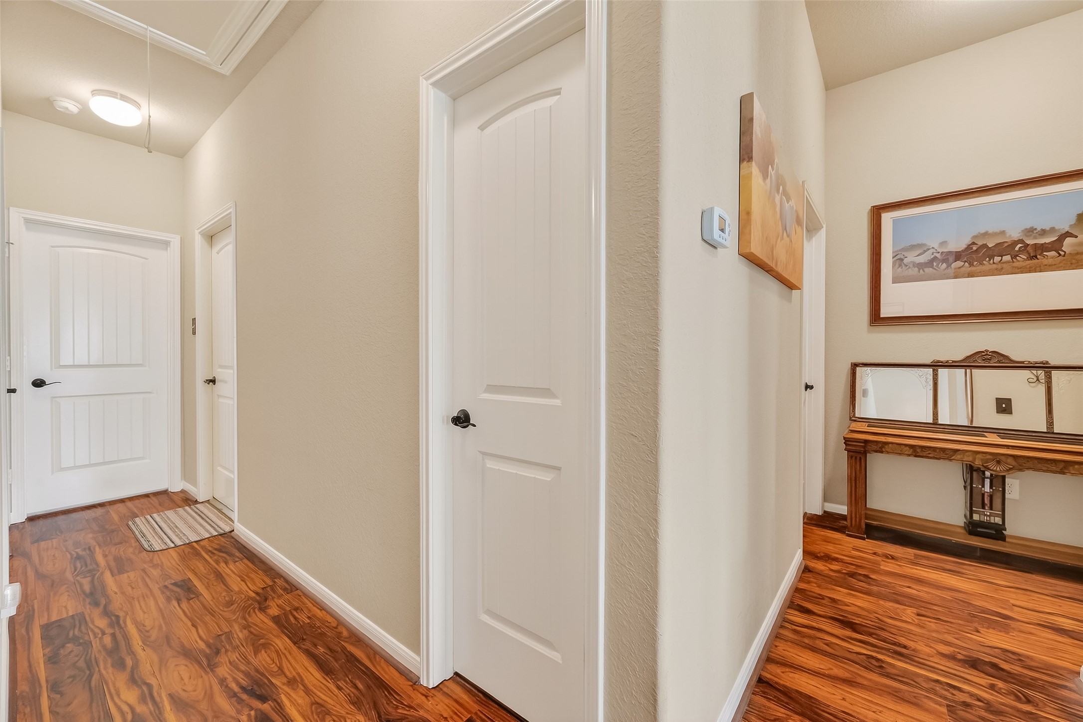 22454 Toronado Ridge Lane Porter, TX 77365 - Photo 16 of 33 A welcoming hallway with warm wood flooring and neutral walls.