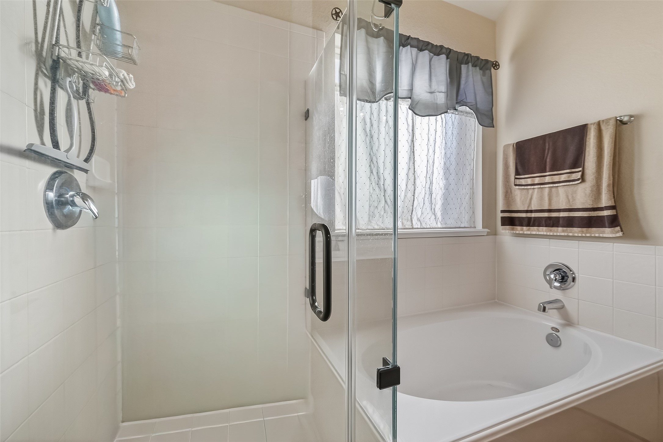 22454 Toronado Ridge Lane Porter, TX 77365 - Photo 26 of 33 This bathroom features a spacious walk-in shower with glass doors alongside a cozy bathtub.