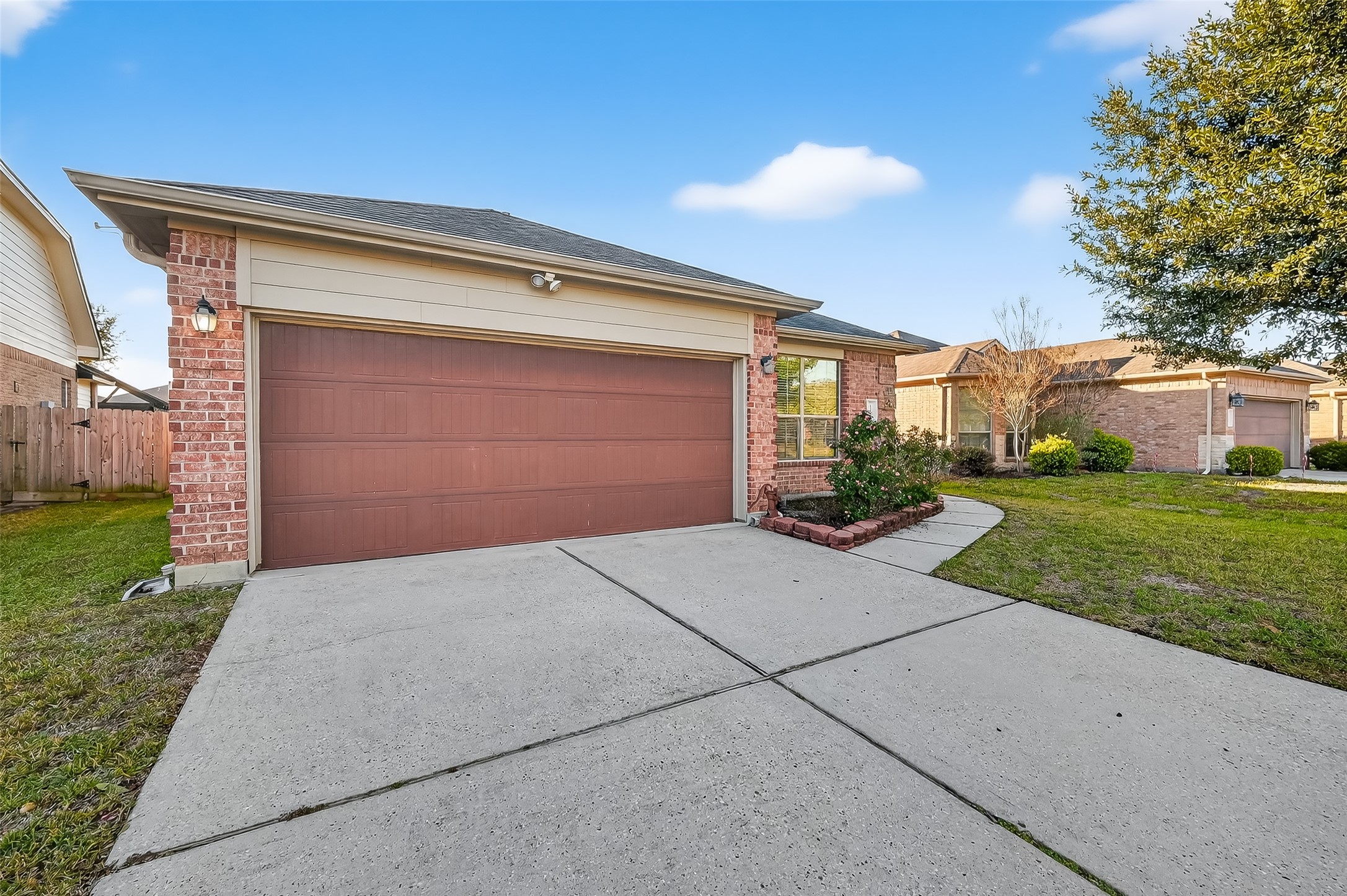 22454 Toronado Ridge Lane Porter, TX 77365 - Photo 3 of 33 This is a charming single-story brick home with a two-car garage. It features a well-maintained front yard and a neat pathway leading to the entrance. The exterior is complemented by a mix of brick and siding, offering a welcoming curb appeal.