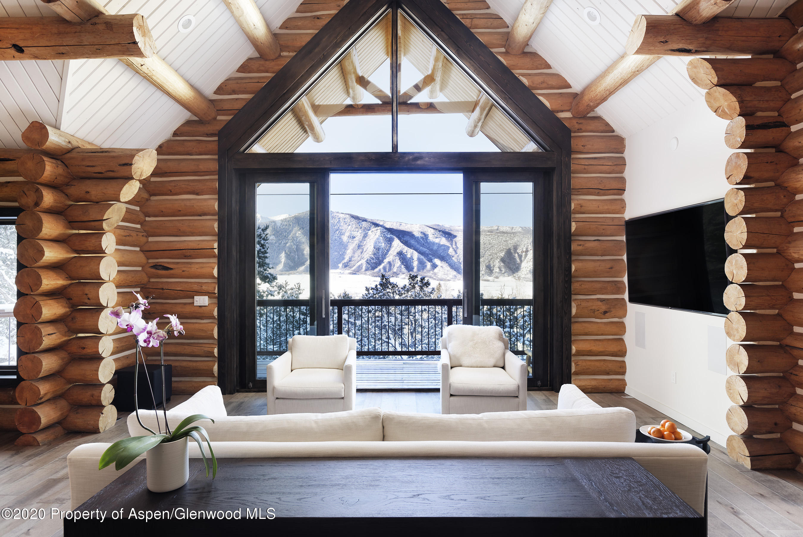 a living room with furniture and a floor to ceiling window