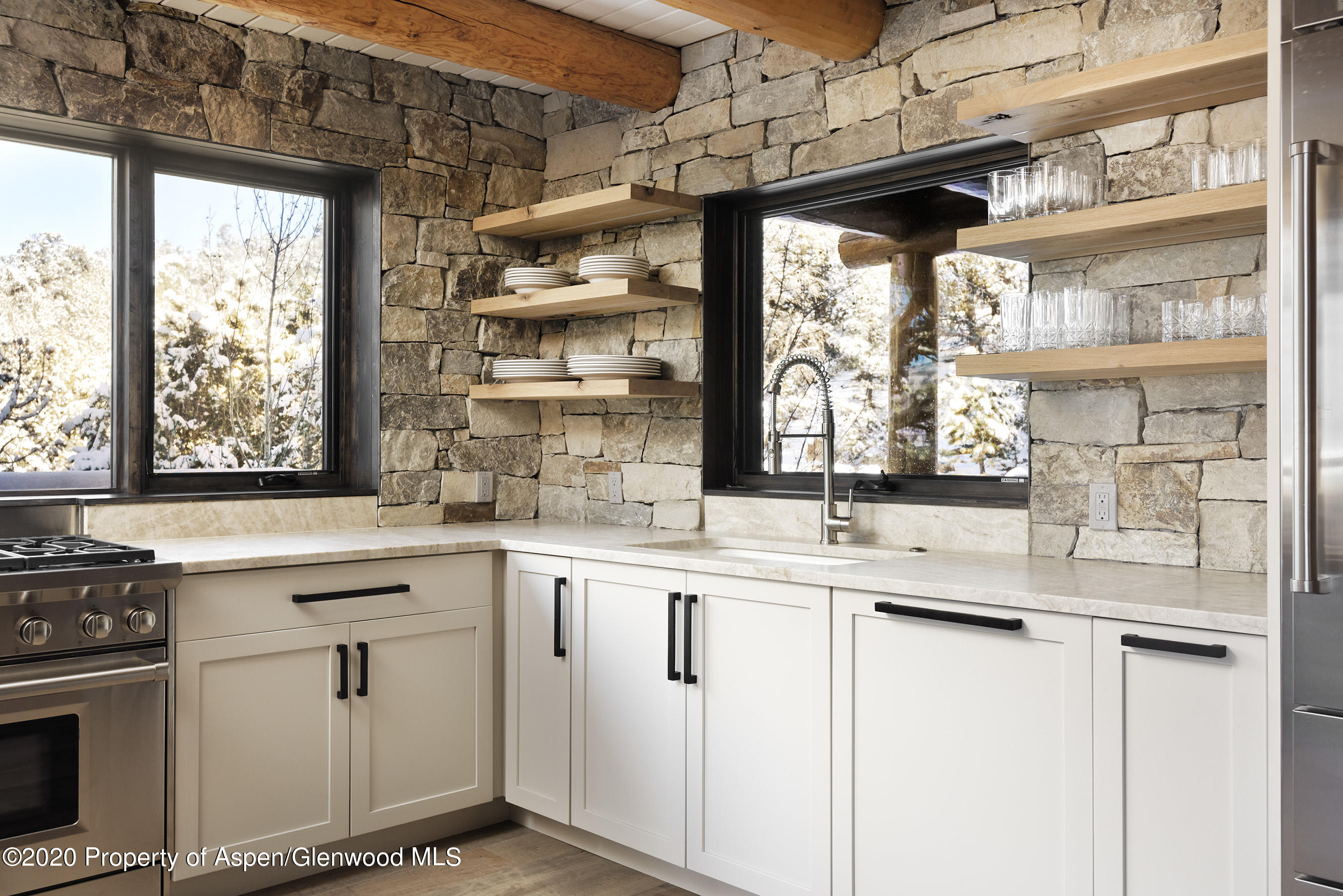 844 Hillcrest Drive Basalt, CO 81621 - Photo 7 of 27 a kitchen with stainless steel appliances granite countertop a sink and a window