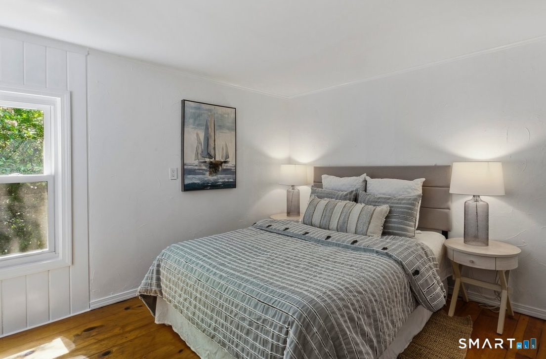 188 Bacon Road Roxbury, CT 06783 - Photo 15 of 33 a bedroom with a bed and wooden floor