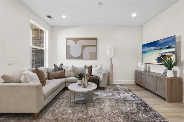 a living room with furniture and a potted plant