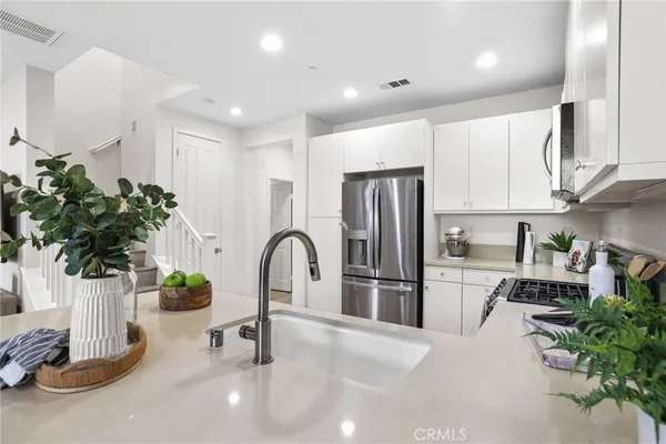 a kitchen with stainless steel appliances a refrigerator and a sink