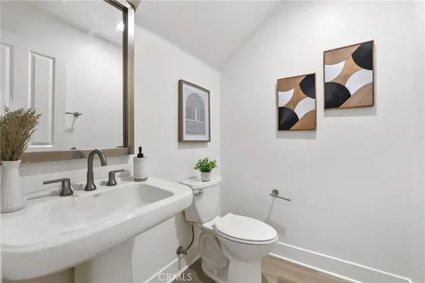 a bathroom with a sink mirror and toilet