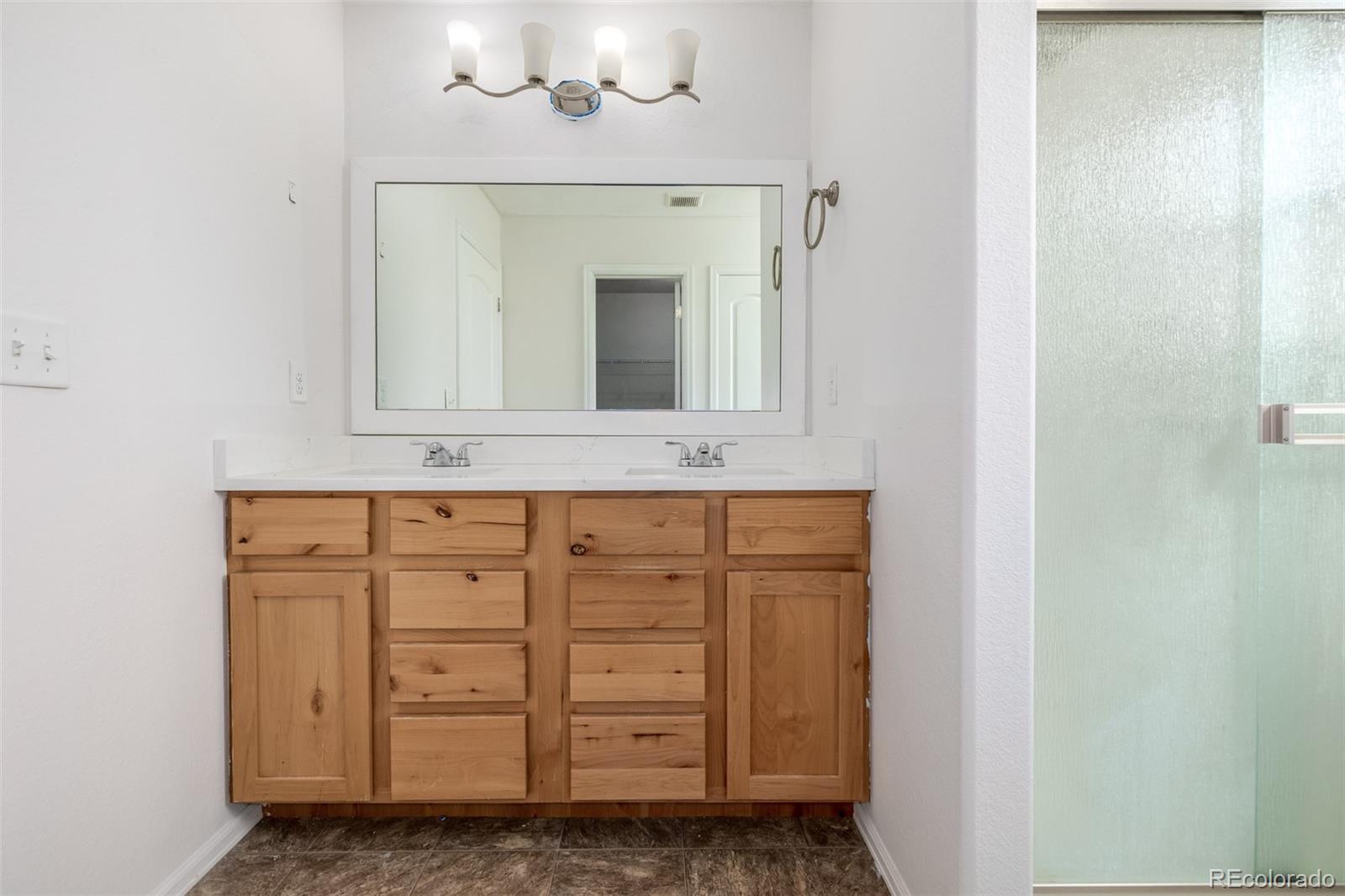 2188 Grain Bin Windsor, CO 80550 - Photo 13 of 30 a bathroom with a sink and a mirror