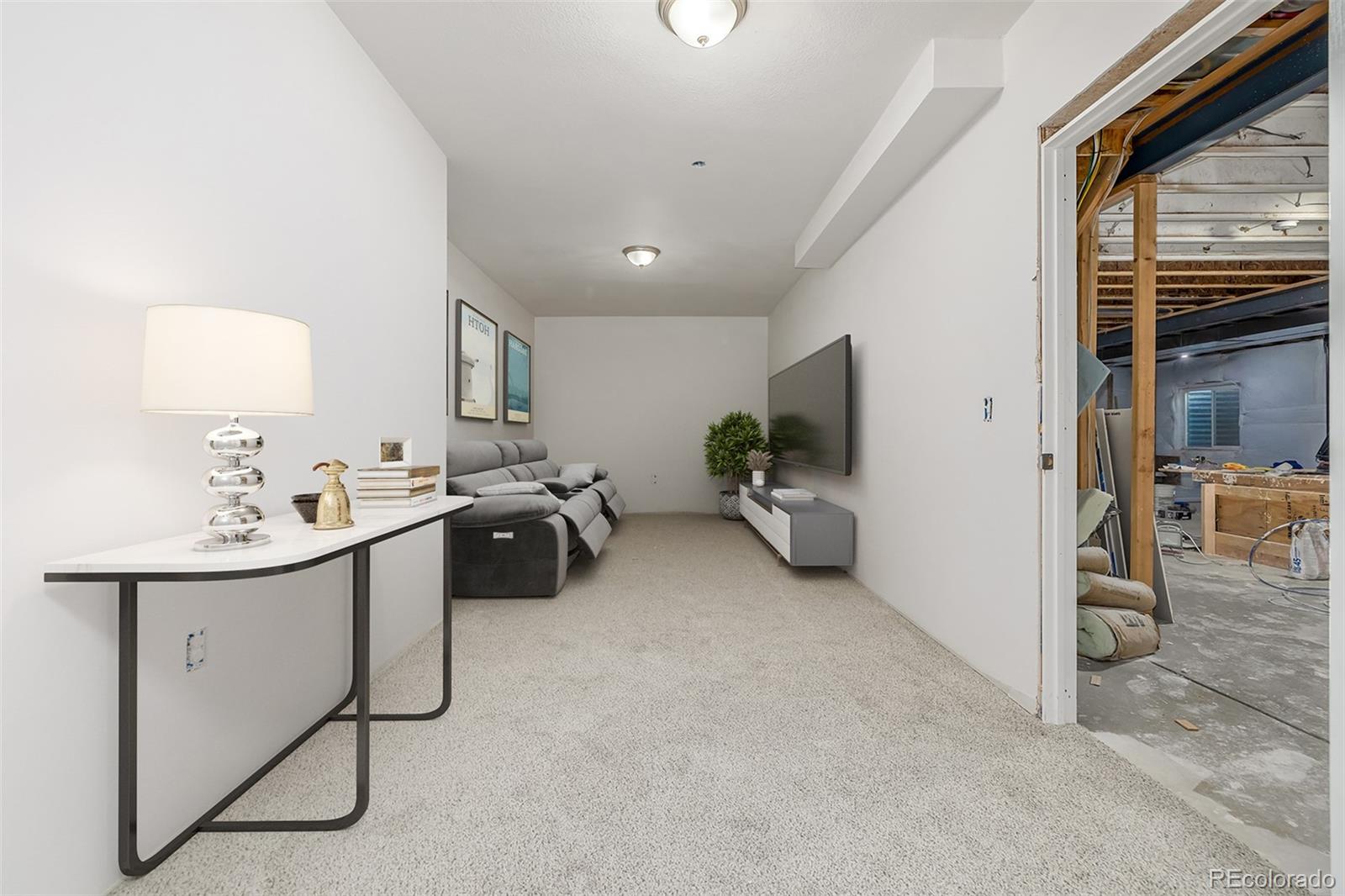 2188 Grain Bin Windsor, CO 80550 - Photo 19 of 30 a view of a livingroom with furniture and a flat screen tv