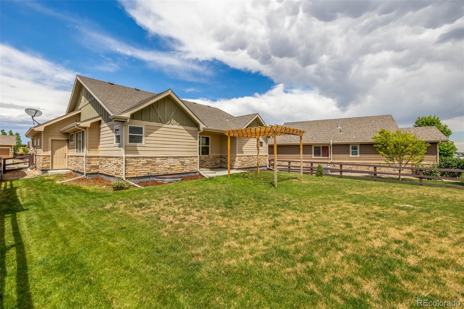 2188 Grain Bin Windsor, CO 80550 - Photo 24 of 30 a front view of a house with a garden