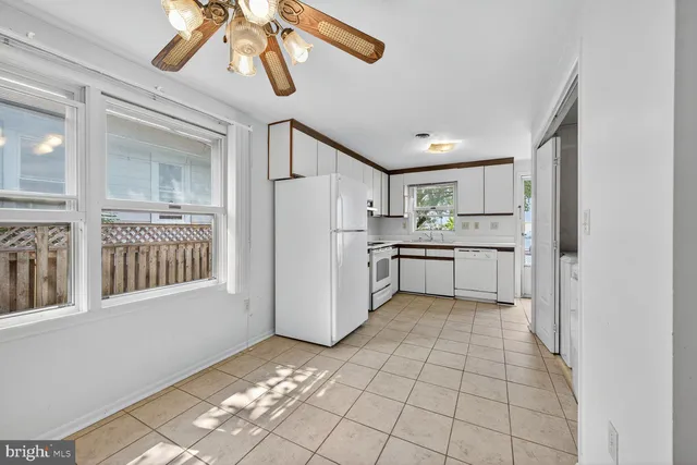a kitchen with a refrigerator a microwave and cabinets