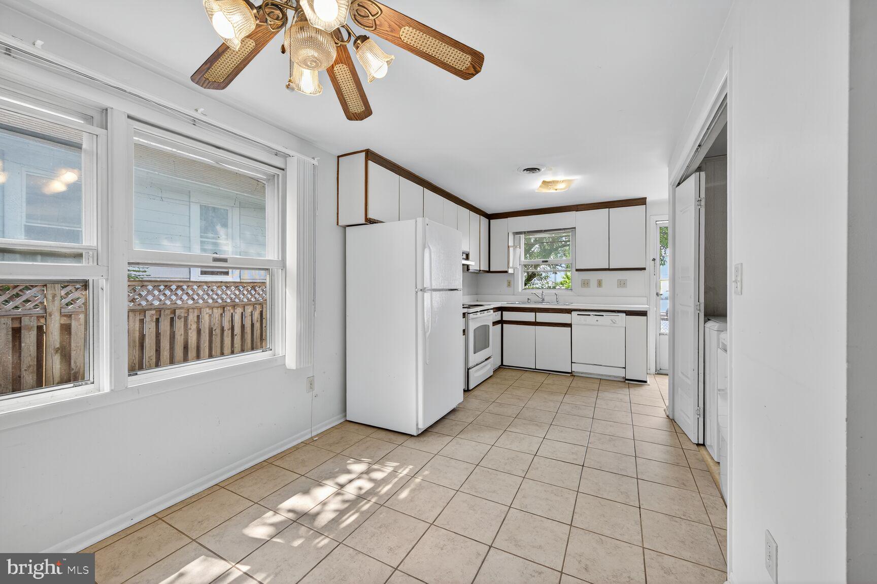 816 Islington Street Silver Spring, MD 20910 - Photo 11 of 18 a kitchen with a refrigerator a microwave and cabinets