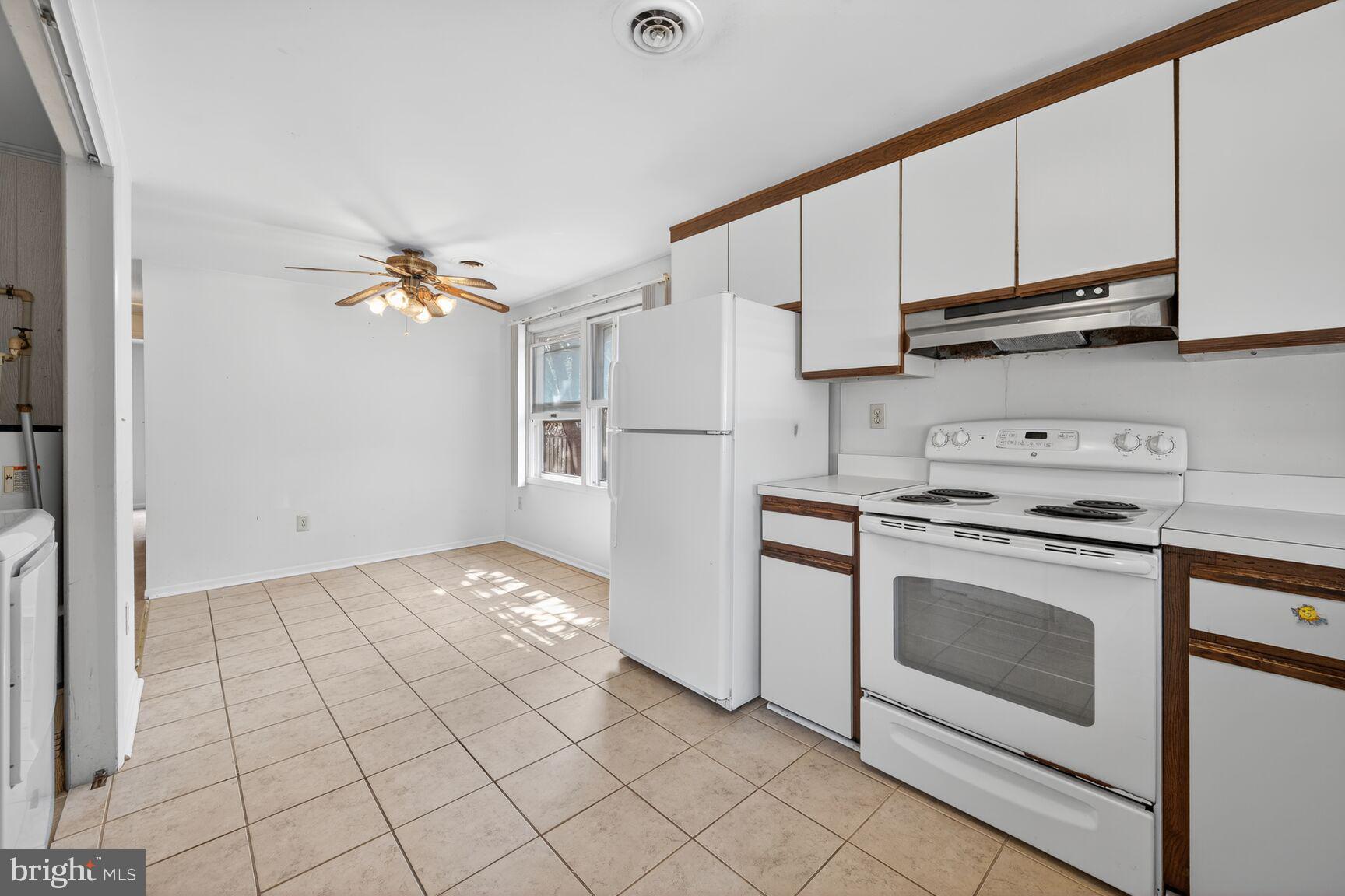 816 Islington Street Silver Spring, MD 20910 - Photo 13 of 18 a kitchen with granite countertop a stove a sink and a refrigerator
