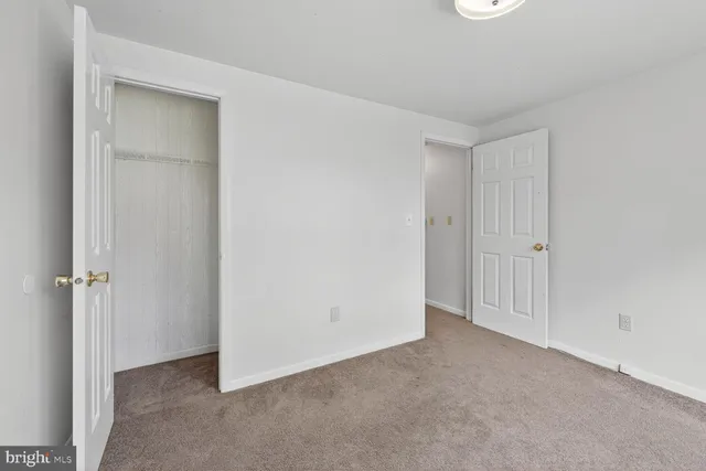an empty room with closet area