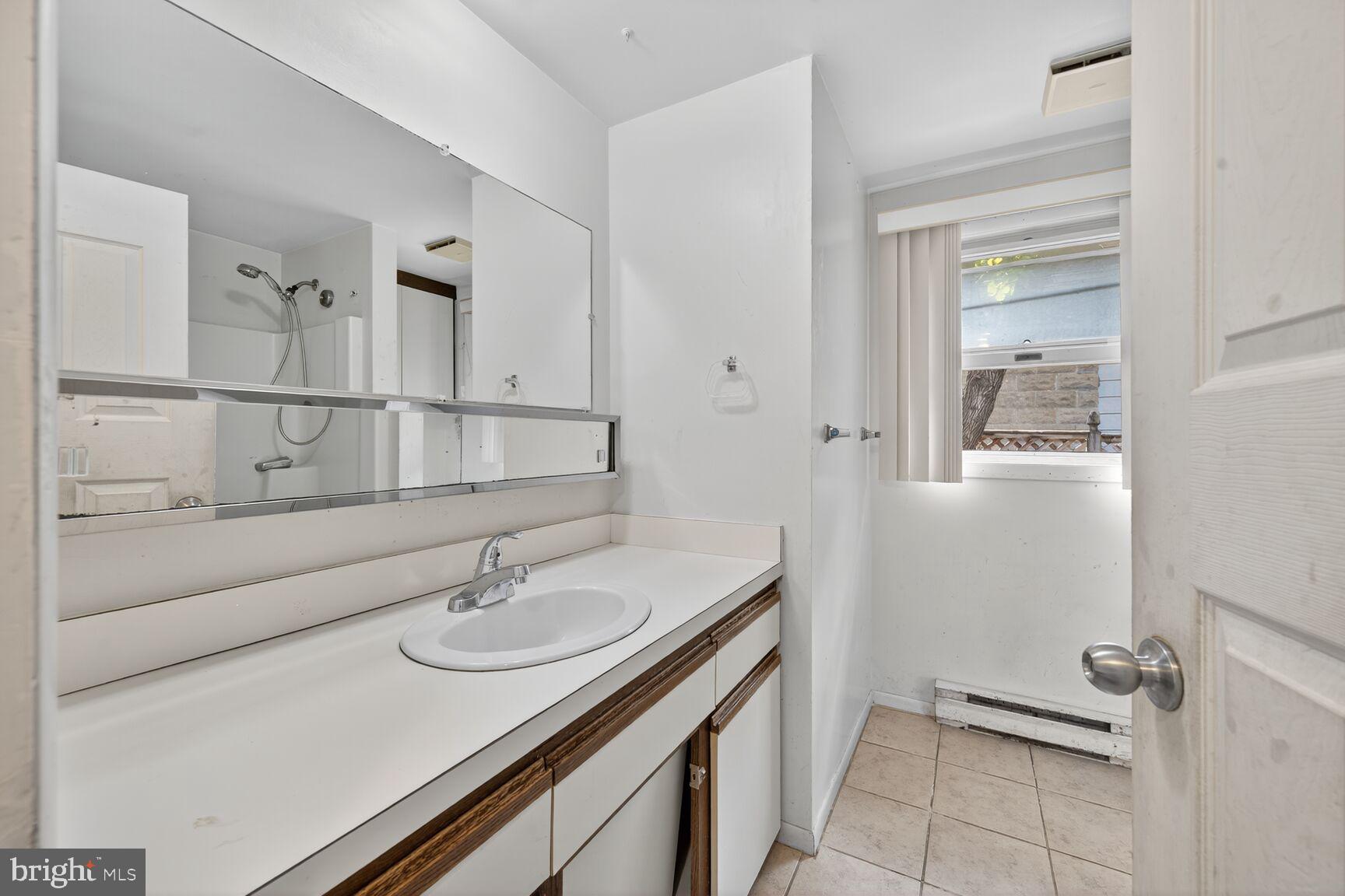 816 Islington Street Silver Spring, MD 20910 - Photo 10 of 18 a bathroom with a sink double vanity and a mirror