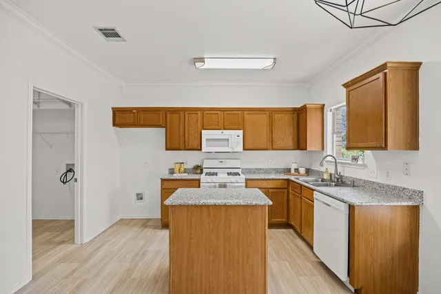 a kitchen with a sink stove top oven and cabinets