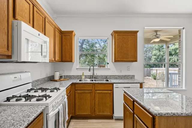 a kitchen with stainless steel appliances a stove a sink and a microwave