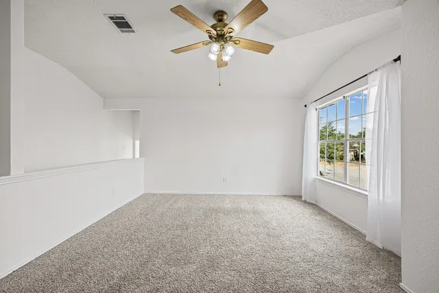 a view of room with window and ceiling fan